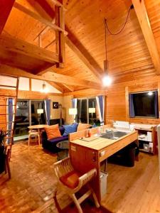 a kitchen and living room with a wooden ceiling at Gubo Satoyama Suite Lodge & Camp - Vacation STAY 39508v in Katsuura