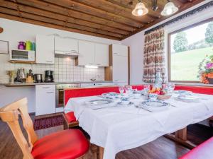 a dining room with a table and a kitchen at Schwoichbauer II in Saalbach Hinterglemm