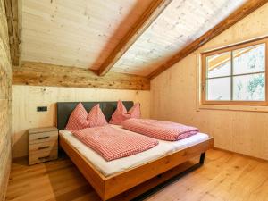 a bedroom in a tiny house with a bed at Heualm in Hopfgarten im Brixental