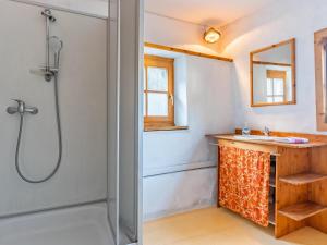 a bathroom with a shower and a sink at Alte Grafenmühle in Hopfgarten im Brixental