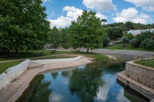 a stream of water in a park with trees at Casa Vale de Água em Santarém in Santarém