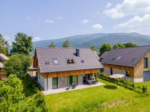an aerial view of a house with mountains in the background at Mountain Chalet Alpinchique in Sankt Lorenzen ob Murau