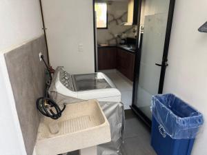 a kitchen with a washing machine and a refrigerator at Hogar Periférico Sur in Lomas de Angelopolis +25 photos