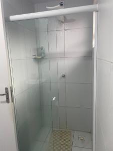 a shower with a glass door in a bathroom at Casa aconchegante in Garanhuns