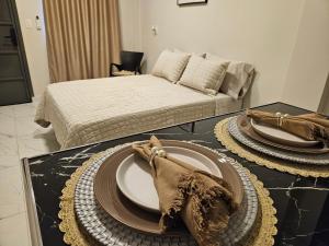 a living room with a table with plates on it at Easy Access Apartment - Ciudad del Este in Ciudad del Este