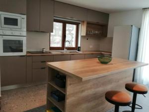 a kitchen with a counter and two stools in it at House Serenity with Pool in Vrgorac