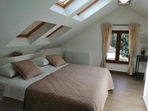 a bedroom with a large bed and a window at House Serenity with Pool in Vrgorac +10 photos