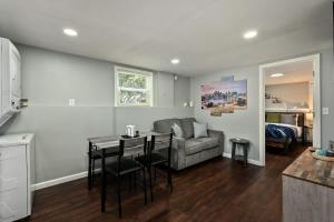 a kitchen and a living room with a table and a couch at 2BR Home KC Stadiums Great Location I-70 in Blue Springs