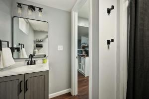 a bathroom with a sink and a mirror at 2BR Home KC Stadiums Great Location I-70 in Blue Springs