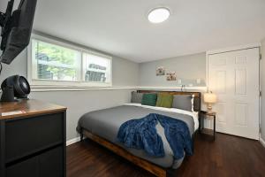 a bedroom with a bed with a blue blanket on it at 2BR Home KC Stadiums Great Location I-70 in Blue Springs +6 photos