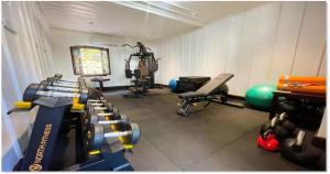 a gym with several exercise equipment in a room at U Luang Prabang in Luang Prabang