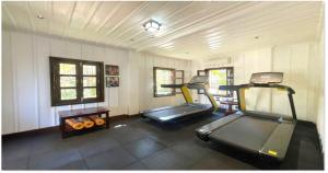 a gym with two exercise bikes in a room at U Luang Prabang in Luang Prabang +34 photos