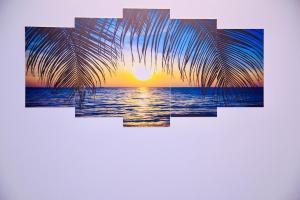 a picture of a palm tree with the sunset at 4BR Apt I 2 King SIZE BED I 2 Queen Size bed I Dhanmondi & Crescent Lake, Dhaka in Dhaka