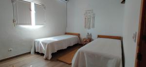 a white room with a bed and a window at Varandas do Vale Furnazinhas in Castro Marim +112 photos