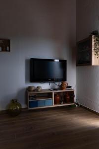 a living room with a flat screen tv on a wall at Varandas do Vale Furnazinhas in Castro Marim
