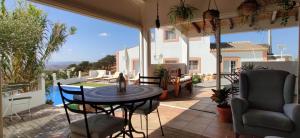 a patio with a table and chairs on a balcony at Varandas do Vale Furnazinhas in Castro Marim