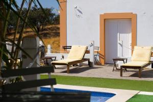 a group of chairs sitting on a patio at Varandas do Vale Furnazinhas in Castro Marim
