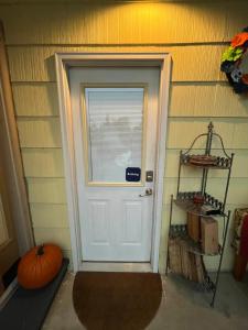 a white door in a room with a pumpkin at GFU neighborhood and Oregon Wine Country studio in Newberg