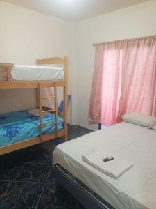 Ένα ή περισσότερα κρεβάτια σε δωμάτιο στο Casa en playas