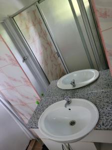 a bathroom with a white sink and a mirror at Shalom Home Stay in Nadi International Airport