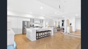 a kitchen with white cabinets and a white counter top at Exclusive Isolated Getaway Mowbray Port Douglas in Mowbray