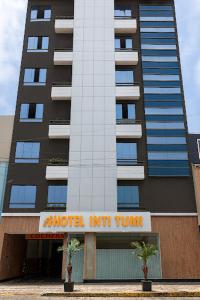 um prédio alto com uma placa de hotel/pousada em Hotel INTI TUMI em Lima