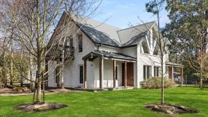 a white house with trees in the yard at 2 Marma Retreat - Peaceful Surrounds with Heated Pool & Spa in Red Hill