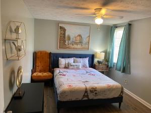 a bedroom with a bed and a chair in it at Cozy 1BR Retreat Historic Peaceful Stay Smart TV VSU in Valdosta