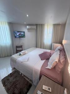 Ένα ή περισσότερα κρεβάτια σε δωμάτιο στο Vila do Morro Pousada