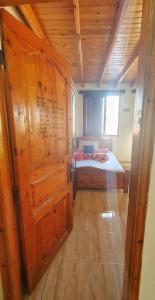 een slaapkamer met een bed en een houten deur bij Dahab House aprtment 3 in Dahab