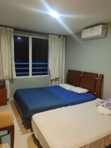a bedroom with two beds and a window at Apartamento cerca Bocagrande in Cartagena de Indias