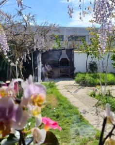 a fireplace in a garden with flowers in front of it at Urban Holiday Retreat in Craiova