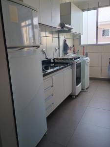 ピンダモニャンガバにあるNosso apêのシンクと冷蔵庫付きのキッチン