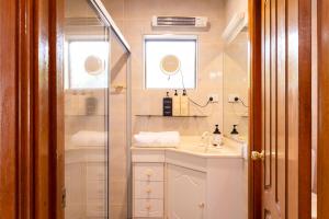 a bathroom with a sink and a shower at Tranquil mountain escape with bushland views in Mount Tamborine +14 photos