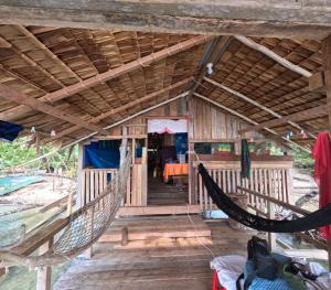 a house with a hammock in front of it at Midemide Island Ecolodge in Mbuini Tusu