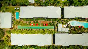 an aerial view of a house with a swimming pool at Mango Lagoon Resort & Wellness Spa in Palm Cove