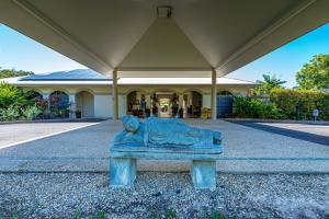 a statue of a lion sitting in front of a building at Mango Lagoon Resort & Wellness Spa in Palm Cove +45 photos