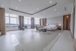 a hotel room with a bed and a living room at ST Central Hotel, Pakse in Pakse