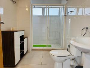a bathroom with a shower and a toilet and a sink at Apartamentos Ramos 3 in Santa Maria +40 photos