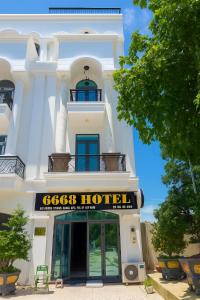 a white building with a hotel sign in front of it at 6668 Hotel - Chi nhánh 2 in Tây Ninh