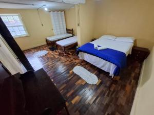 a bedroom with a bed and a bench in it at Aluguel temporada in Ouro Preto