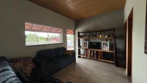 a living room with a couch and a window at Your private paradise 4 suites in Hidrolândia GO in Hidrolândia