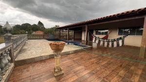 a balcony of a building with a vase on it at Your private paradise 4 suites in Hidrolândia GO in Hidrolândia +5 photos