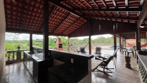 a pavilion with a table and chairs on a deck at Your private paradise 4 suites in Hidrolândia GO in Hidrolândia