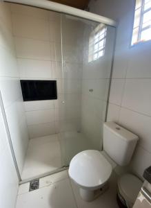a white bathroom with a toilet and a shower at Your private paradise 4 suites in Hidrolândia GO in Hidrolândia