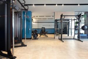 a gym with several treadmills and machines at Flat Infinity 1504 Vista Mar in Itapema