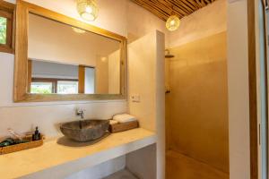 a bathroom with a sink and a mirror at Nativo Lombok Hotel in Kuta Lombok +17 photos