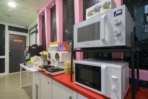 a kitchen with two microwaves and a microwave on a counter at Jeonju COJAJA in Jeonju