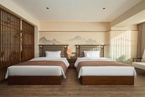 Postel nebo postele na pokoji v ubytování Jijia Inn