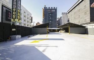 a parking lot in a city with tall buildings at Jeonju COJAJA in Jeonju